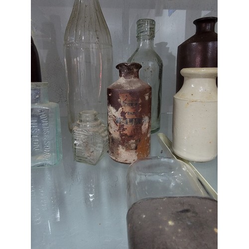 304 - Large quantity of glass and earthenware bottles inc local beer bottles, Al's Sauce, and a quantity o... 