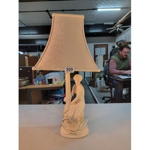 309 - Good quality plaster lamp with a sitting female figure in good order complete with shade stands at 6... 