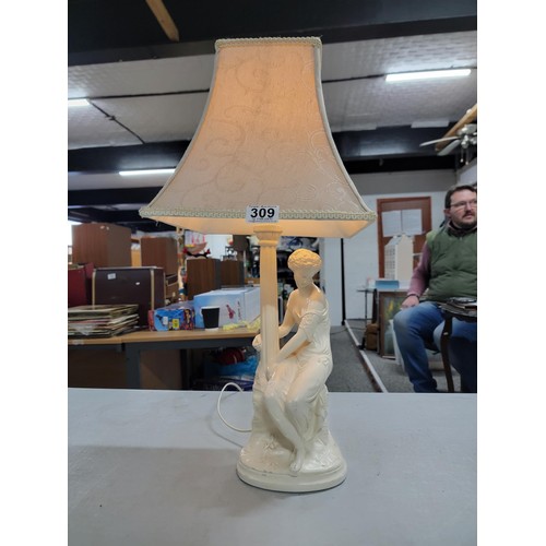 309 - Good quality plaster lamp with a sitting female figure in good order complete with shade stands at 6... 