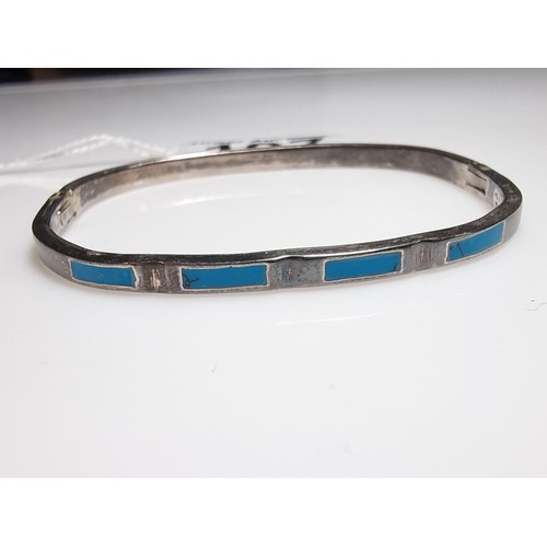 197 - A 925 silver Mexico hinged bangle with blue turquoise inserts.