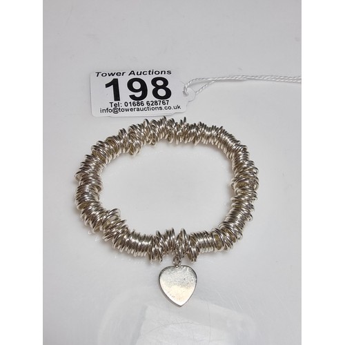 198 - A 925 silver expandable bracelet made up of many 925 silver rings, complete with a heart charm. In e... 