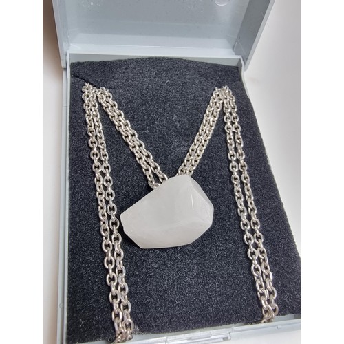 199 - A good quality 925 silver necklace to include a polished rough cut white chalcedony stone pendant on... 