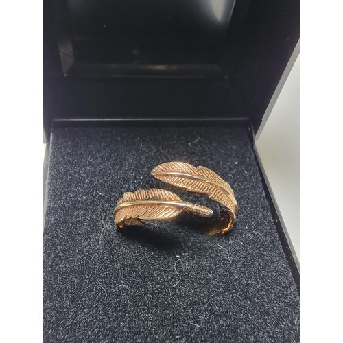 201 - A gold plated on 925 silver feather formed expandable ring. In good clean condition, boxed. Size M a... 