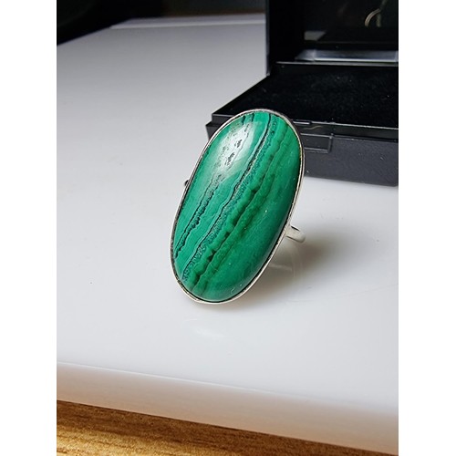 202 - A 925 silver dress ring inset with a large oblong malachite stone presenting a god natural grain. Ap... 