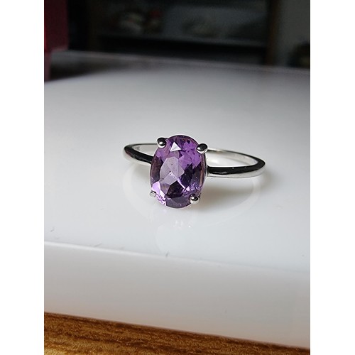 203 - A pretty 925 silver unused ring with a large amethyst stone inset in good clean unused condition, ma... 