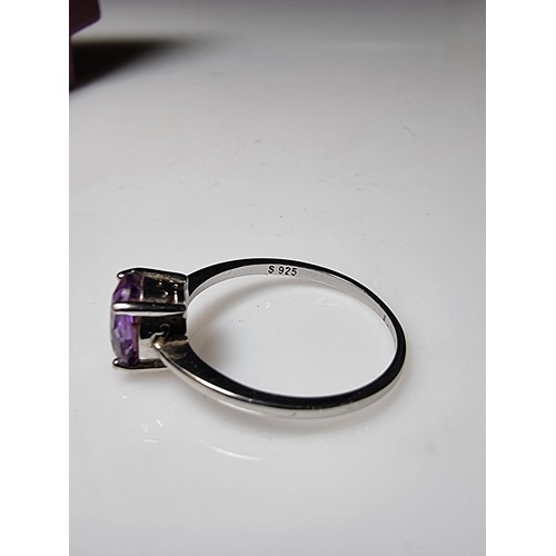 203 - A pretty 925 silver unused ring with a large amethyst stone inset in good clean unused condition, ma... 