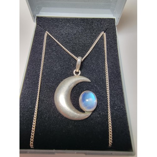 207 - A 925 silver moon pendant inset with a large oval moon stone, the moonstone presents excellent flash... 