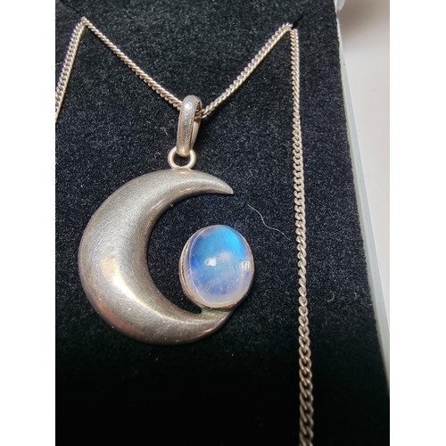 207 - A 925 silver moon pendant inset with a large oval moon stone, the moonstone presents excellent flash... 