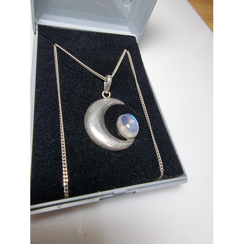 207 - A 925 silver moon pendant inset with a large oval moon stone, the moonstone presents excellent flash... 