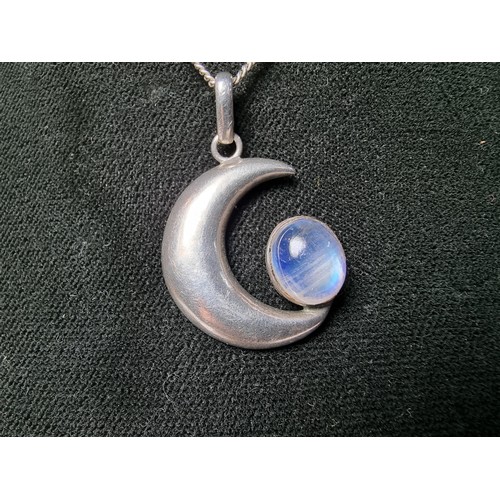 207 - A 925 silver moon pendant inset with a large oval moon stone, the moonstone presents excellent flash... 