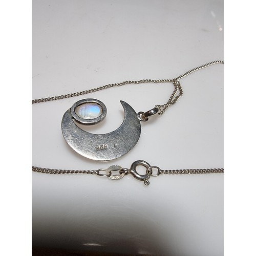 207 - A 925 silver moon pendant inset with a large oval moon stone, the moonstone presents excellent flash... 