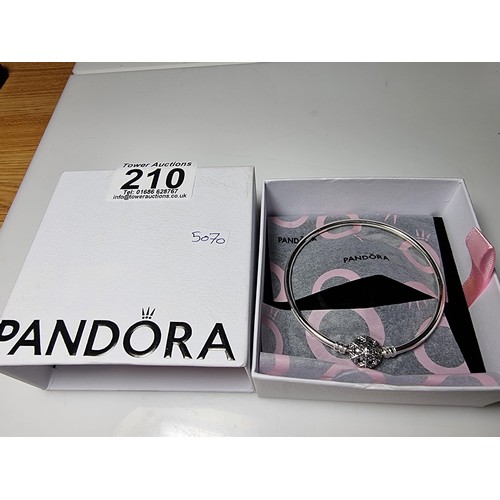 210 - A genuine Pandora 925 silver bangle with a snowflake charm inset with a crystal CZ stone, marked S92... 