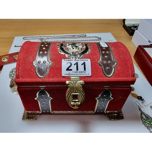 211 - An ornate toffee tin full of good fitted costume jewellery to include ornate earrings, brooches, nec... 