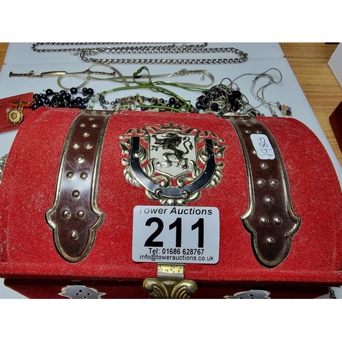 211 - An ornate toffee tin full of good fitted costume jewellery to include ornate earrings, brooches, nec... 