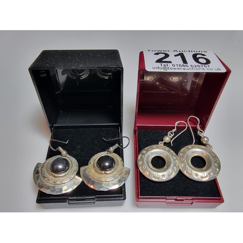 216 - 2 pairs of large 925 silver drop earrings both in good condition and boxed.