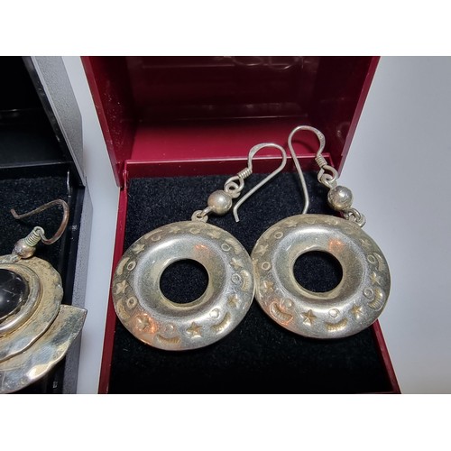 216 - 2 pairs of large 925 silver drop earrings both in good condition and boxed.