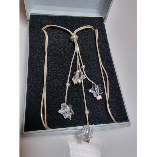 218 - A 925 silver double strand necklace with long crystal glass star drops on an 18