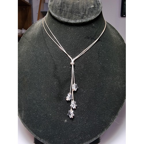 218 - A 925 silver double strand necklace with long crystal glass star drops on an 18