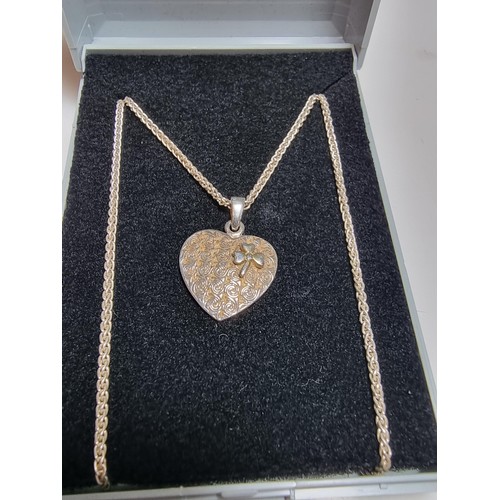 221 - A 925 silver heart pendant with a 3 leaf clover set on a good 18