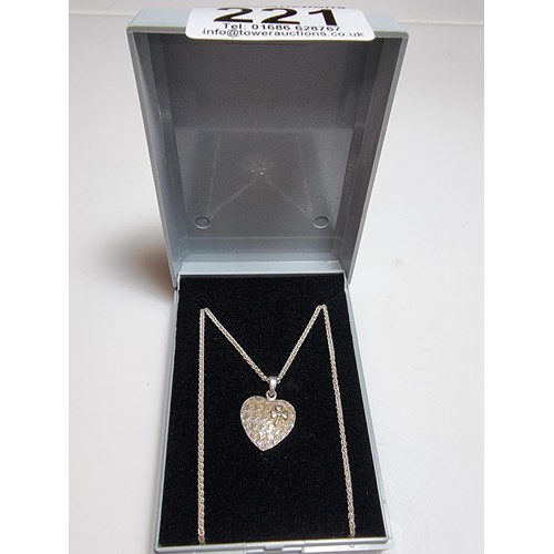 221 - A 925 silver heart pendant with a 3 leaf clover set on a good 18