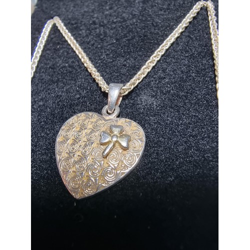 221 - A 925 silver heart pendant with a 3 leaf clover set on a good 18