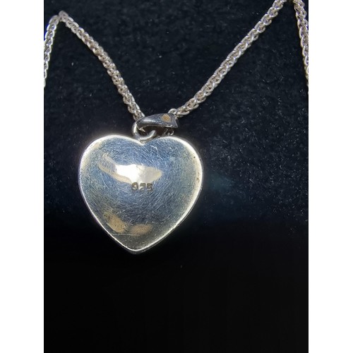 221 - A 925 silver heart pendant with a 3 leaf clover set on a good 18