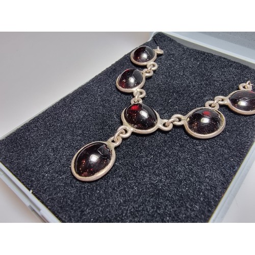 228 - A pretty 925 silver drop necklace inset with red garnet stones, in excellent clean condition, boxed ... 