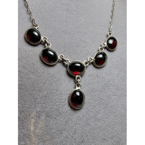 228 - A pretty 925 silver drop necklace inset with red garnet stones, in excellent clean condition, boxed ... 