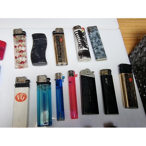 230 - A large collection of various vintage lighters including a good selection of clipper lighters, adver... 