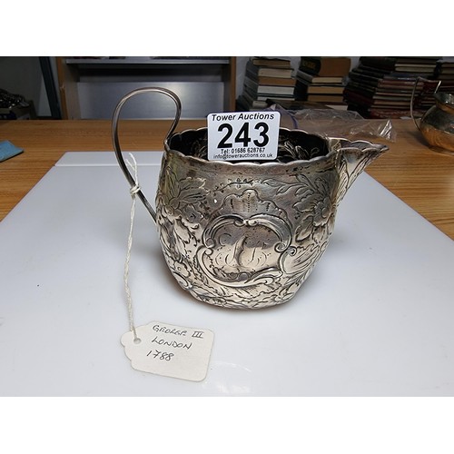 243 - A fine quality George III hallmarked silver milk jug with an ornate engraved and embossed design, ha... 