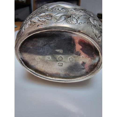 243 - A fine quality George III hallmarked silver milk jug with an ornate engraved and embossed design, ha... 