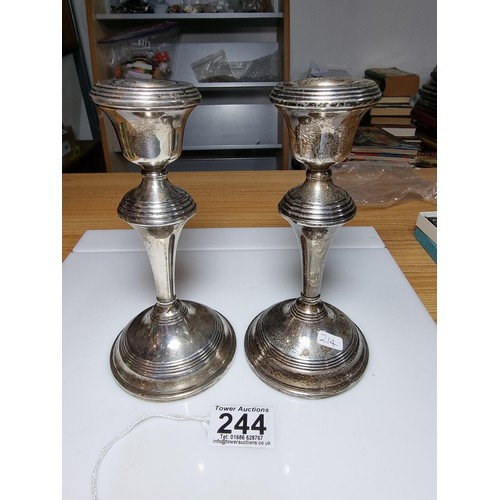 244 - A pair of hallmarked solid silver candlesticks with weighted bases, hallmarked for Birmingham 1960 b... 