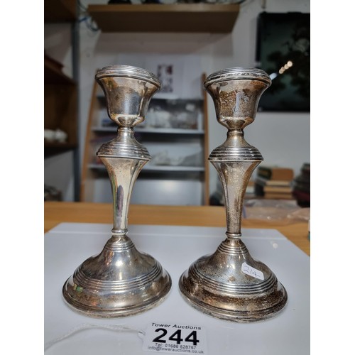 244 - A pair of hallmarked solid silver candlesticks with weighted bases, hallmarked for Birmingham 1960 b... 