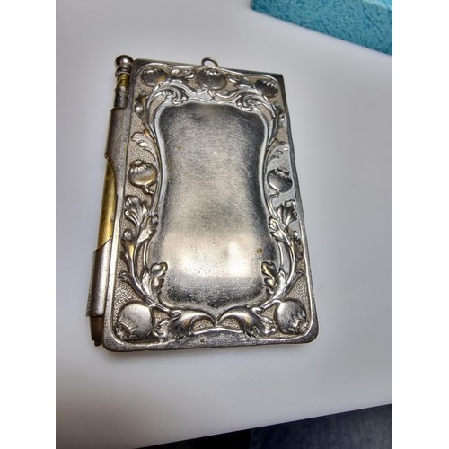 245 - A vintage Art Nouveau silver plated hand held note pad holder with pencil with an ornate design to t... 