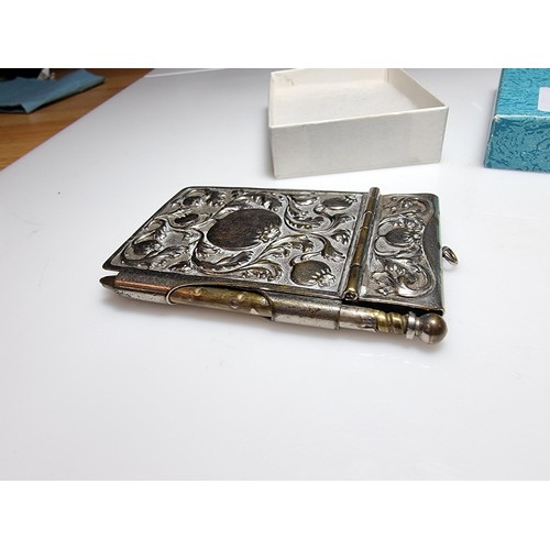 245 - A vintage Art Nouveau silver plated hand held note pad holder with pencil with an ornate design to t... 