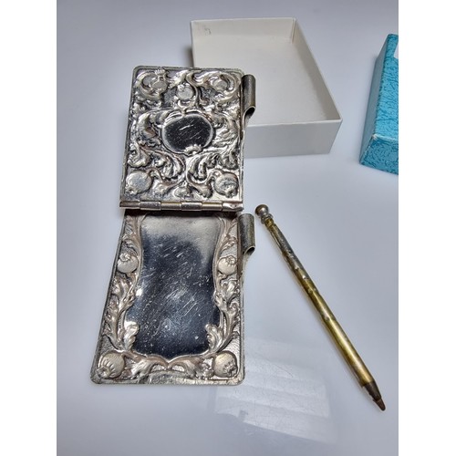 245 - A vintage Art Nouveau silver plated hand held note pad holder with pencil with an ornate design to t... 