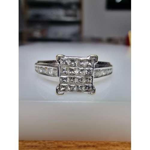 247 - A stunning hallmarked 9ct white gold and diamond engagement ring with 16 square diamonds to the cent... 