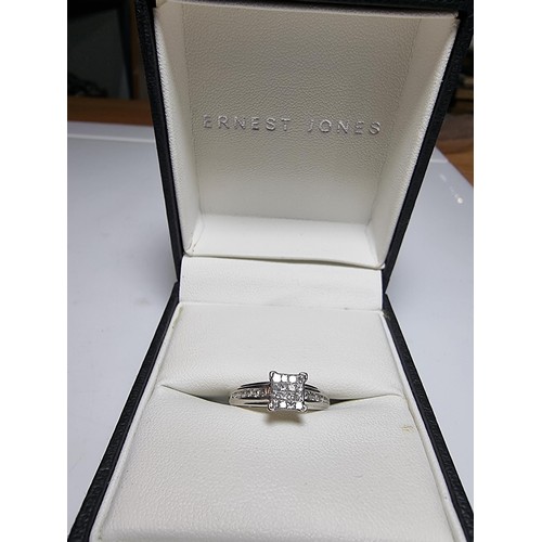 247 - A stunning hallmarked 9ct white gold and diamond engagement ring with 16 square diamonds to the cent... 