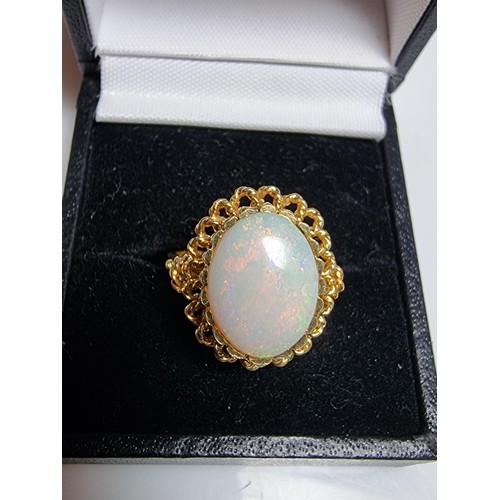 248 - A beautiful 18ct yellow gold ornate ring inset with a large oval genuine white opal stone having fie... 