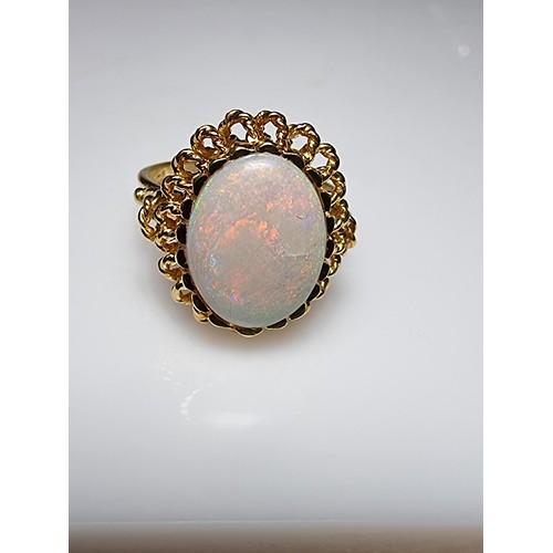 248 - A beautiful 18ct yellow gold ornate ring inset with a large oval genuine white opal stone having fie... 