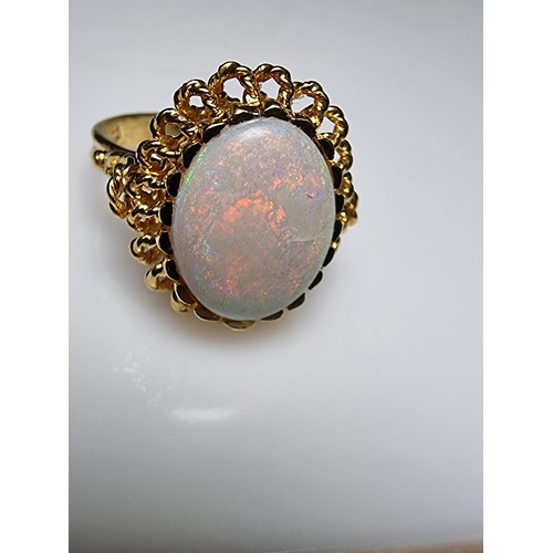 248 - A beautiful 18ct yellow gold ornate ring inset with a large oval genuine white opal stone having fie... 