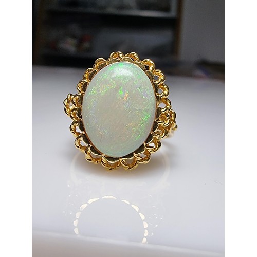 248 - A beautiful 18ct yellow gold ornate ring inset with a large oval genuine white opal stone having fie... 