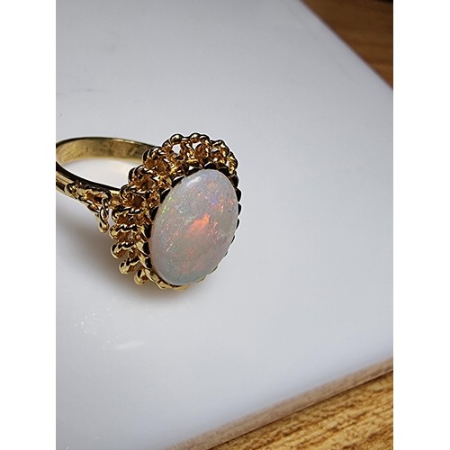 248 - A beautiful 18ct yellow gold ornate ring inset with a large oval genuine white opal stone having fie... 