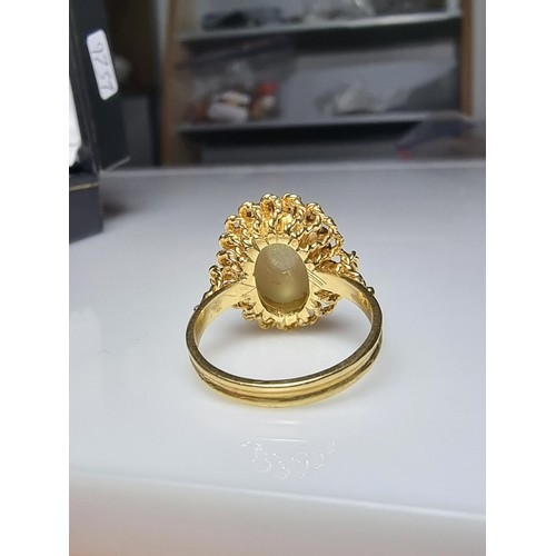 248 - A beautiful 18ct yellow gold ornate ring inset with a large oval genuine white opal stone having fie... 