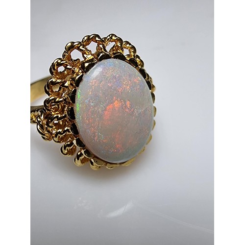 248 - A beautiful 18ct yellow gold ornate ring inset with a large oval genuine white opal stone having fie... 