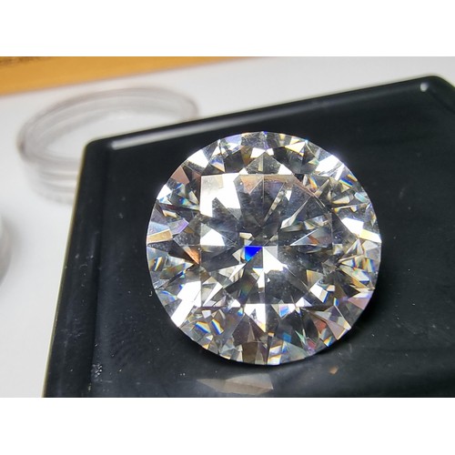 253 - A 10ct moissanite diamond with a diameter of 14mm with full report, the moissanite has a colour grad... 