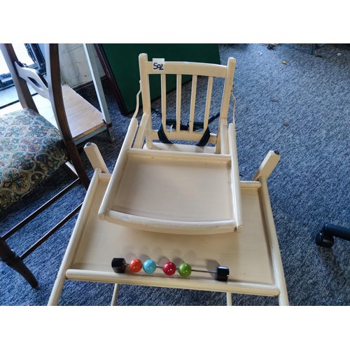 502 - a metamorphic child's high chair of timber construction converts into a desk/table