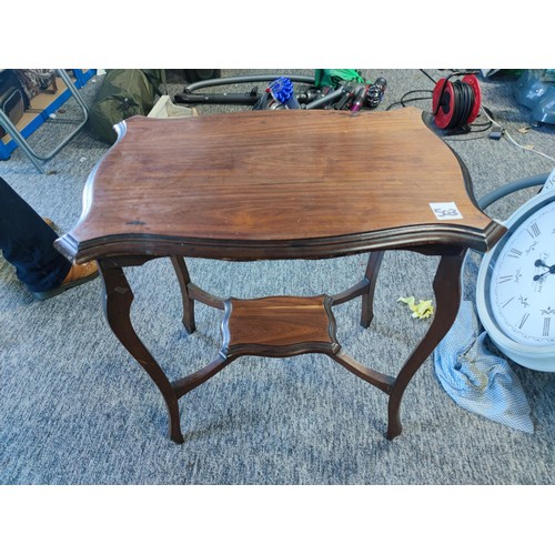 503 - An Edwardian window table, shelf to lower section made in mahogany showing great patina