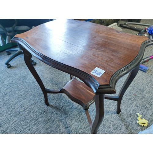 503 - An Edwardian window table, shelf to lower section made in mahogany showing great patina