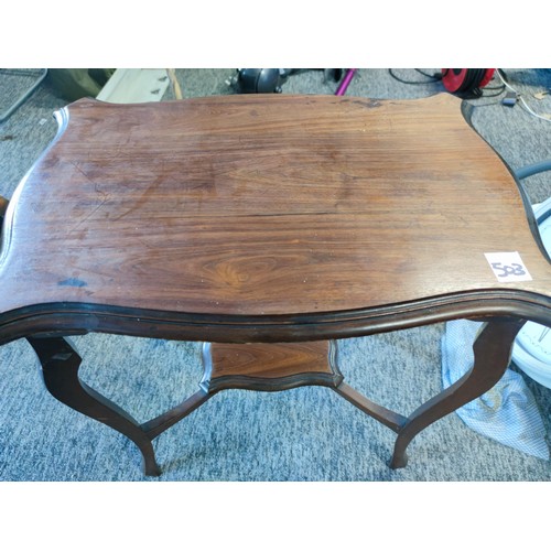 503 - An Edwardian window table, shelf to lower section made in mahogany showing great patina